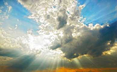 Naklejka na ściany i meble Beams of the sun make the way through clouds