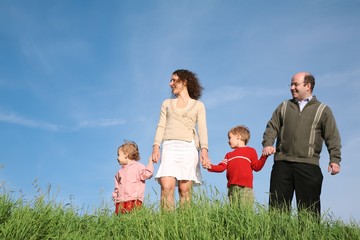 family on the meadow look away