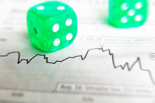 Closeup of dice on a stock market graph