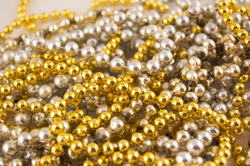 golden and silver beads laying together