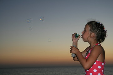 girl blowing a bubble