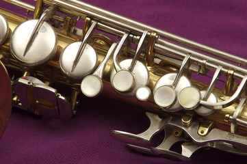 Saxophone against purple, alto, upper keys rim of the horn