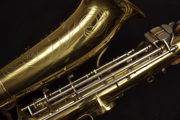 Saxophone against black, horn and middle keys