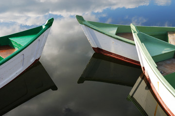 Fototapeta na wymiar Small white and green wooden boats