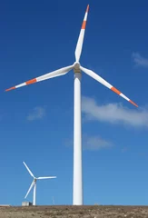 Photo sur Plexiglas Moulins two wind mill power generators against blue sky