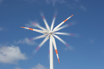 wind mill power generator against blue sky