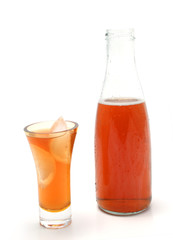 bottle and glass with ice cubes full of ice tea