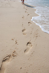 Walking on beach. Footprints on sand.
