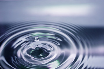 water droplet as it just hits water below