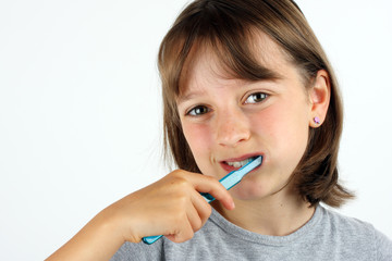 Young girl brushing her teeth