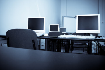 Computer classroom. Computers in row in school classroom