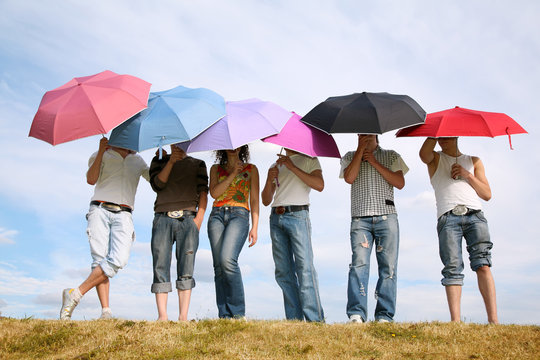 group of people under umbrellas