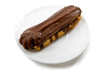 chocolate cake (eclair) on plate isolated over white