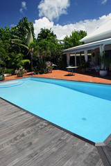 Piscine devant une villa blanche.