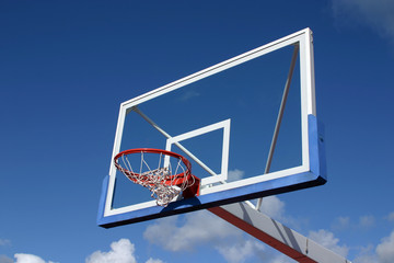 Basketball basket on blue sky background.
