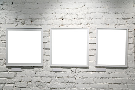 wall in the exebition hall with blank frames