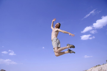 healthy happy man jumping in joy of life