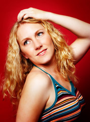 Obraz premium Pretty blond girl on red
