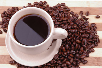 a cup of coffee with beans as background