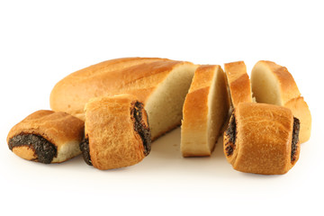 The cut long loaf and rolls on a white background.
