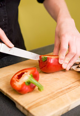 Female Slicing a Red Pepper