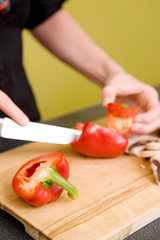 Obraz na płótnie Canvas Female Slicing a Red Pepper
