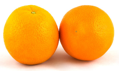 Two oranges side by side on a white background