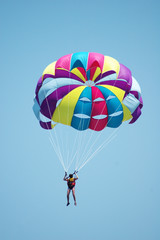 Fototapeta premium Multi coloured parachute over the blue sky