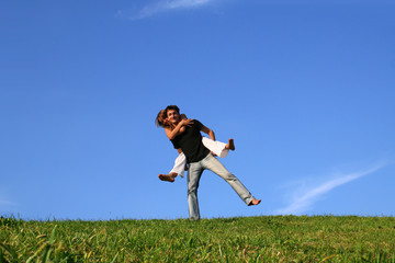 Happy boy and girl in a meadow