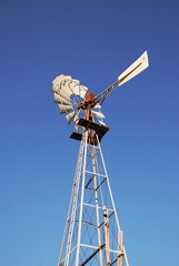rusty old water pumping windmill