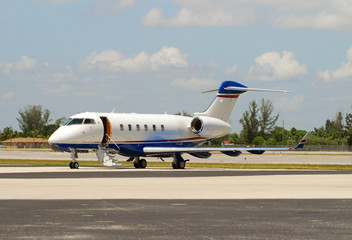 Private learjet parked on runway