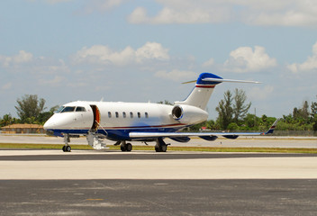 Private learjet parked on runway © icholakov