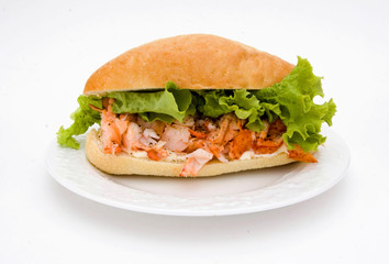 A delicious lobster sandwich with lettuce and a bun.