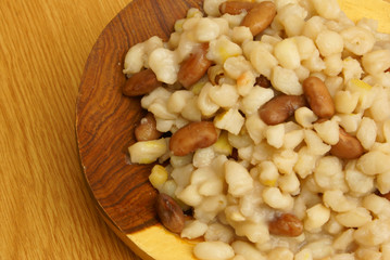 Samp with beans on the big wooden spoon - close-up