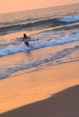 Fototapeta na wymiar Female surfer heading for the last ride
