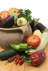 set of fresh vegetables with old clay pot
