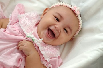 Cute Baby Girl in Pink Laughing