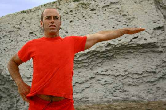 A man doing exsercise in the beach