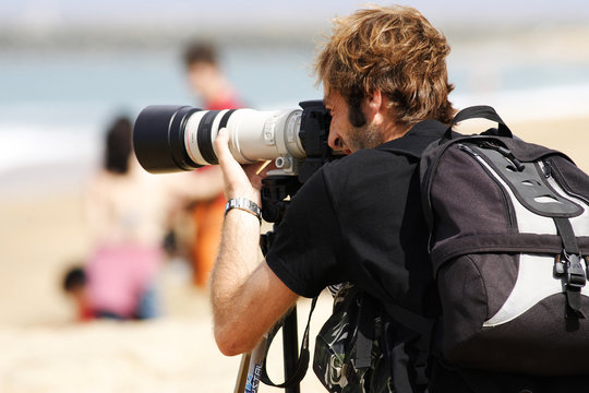 Fototapeta photographe entrain de zoomer