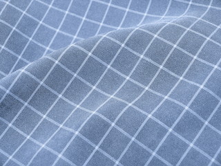 Pleated checkered blue fabric close up. Good for background.