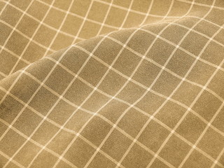 Pleated checkered brown fabric close up. Good for background.
