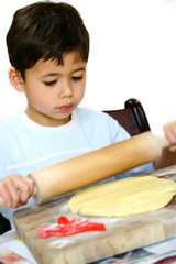 A young boy making cookies, 
