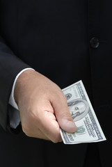 Hand holding a one hundred dollar bill