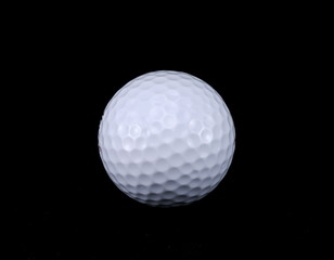 Golf ball isolated on black