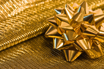 golden bow on golden background