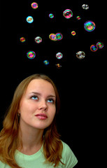 girl playing with lots of soap bubbles