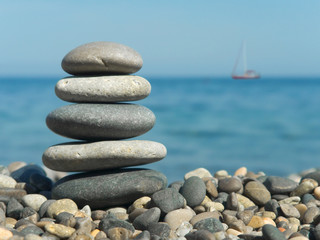 Stack of stones and yacht