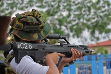 Man testing the riffle in the camps