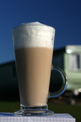 Cafe Latte in a tall glass and deep blue sky