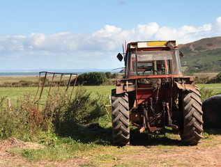 Agricultural Tractor on a Field overlooking the Sea